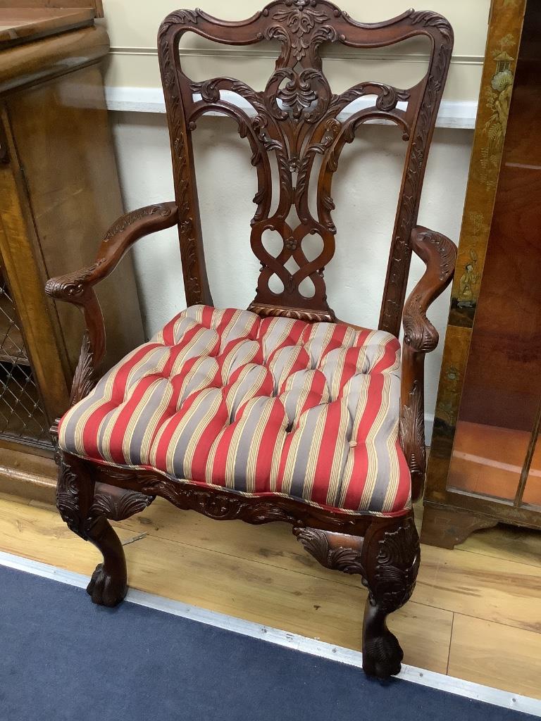 A pair of George III style Irish design mahogany elbow chairs